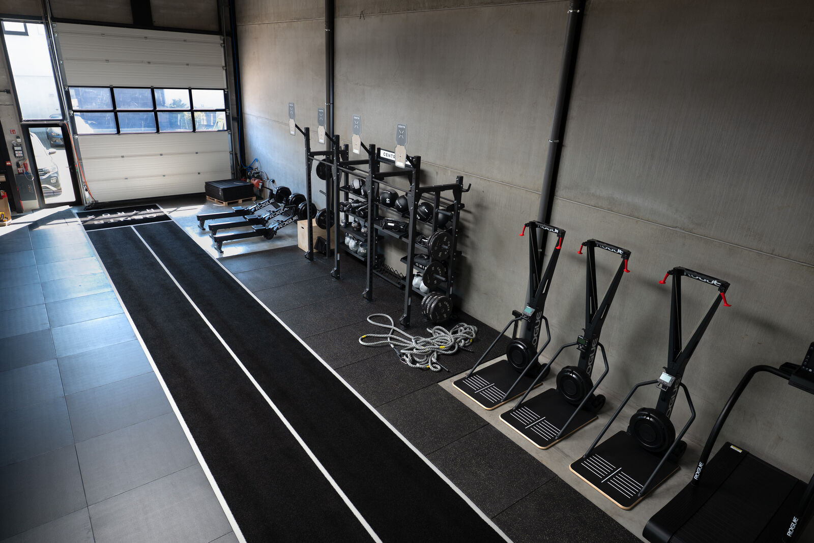 Ski ergs and rowers along the lanes